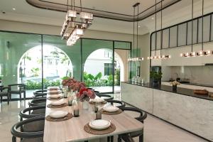 a dining room with a long table and chairs at Title Legendary Studio with Balcony by TVC C407 in Bang Tao Beach