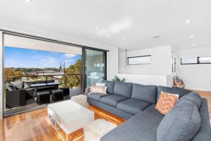 a living room with a couch and a table at Bayview Luxe- Sleeping 14, Pet Friendly, Views- 4 bedroom, lounge with sofa beds in Curlewis