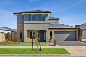 a house with a garage in front of it at City & Surf Getaway in Grovedale