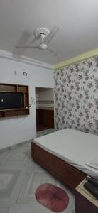 a bedroom with a bed and a ceiling fan at Hotel relaxinn in Saharsa