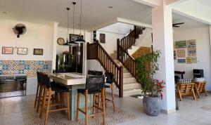 a kitchen with a staircase and a table and chairs at Villa Padi in Canggu