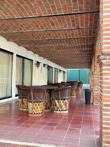 a row of chairs and tables on a patio at Ribera del Lago in Jocotepec