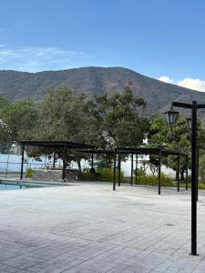 a pavilion with a lamp and a swimming pool at Ribera del Lago in Jocotepec