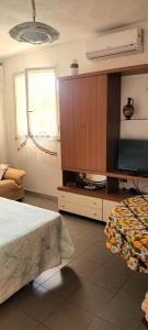a bedroom with a tv and a bed and a cabinet at Mare e relax in Tropea