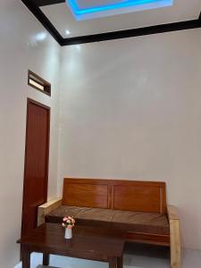 a room with a wooden bed and a table at Leuser Inn & Jungle Trekking in Bukit Lawang +94 photos