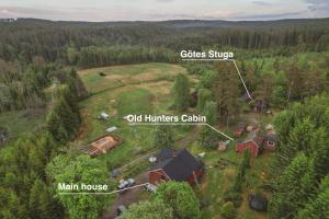 an aerial view of a house in a forest at Farmstay Outdoor Old Hunters Cabin, 2p in Årjäng +25 photos