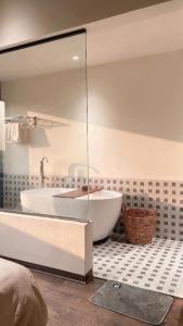 a large bathroom with a tub and a sink at Casa de Holu Homestay in Ða Gia