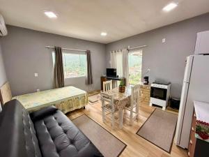 a living room with a couch and a table at Kit Net in Governador Celso Ramos
