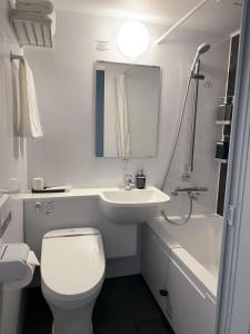 a white bathroom with a toilet and a sink at Leisure Hotel II 東中野 in Tokyo +34 photos