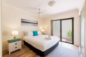 a bedroom with a bed and a window at Breakers 1-3 - Ocean Views - Stone Real Estate Yamba in Yamba +6 photos