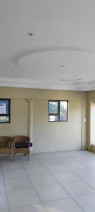 a empty room with two benches and two windows at RestZone Healing Guest Suite in Pietermaritzburg