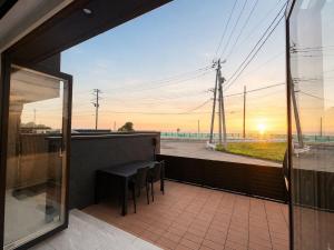 a balcony with a table and chairs and a view at Coco Resort Futtsu in Futtsu +52 photos