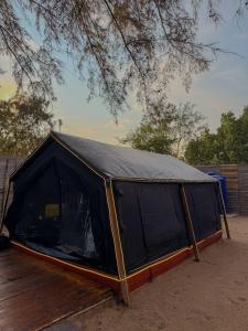 a black tent sitting on top of a wooden deck at Coody Seastar in Ban U Taphao