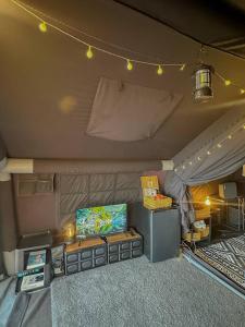 a room with a tent with a tv and lights at Coody Seastar in Ban U Taphao +6 photos