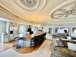 an open kitchen and living room with a large island at Capel Mawr in Llanrug