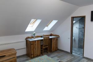 a bathroom with skylights and a sink in a room at Casa Róza Vendégház in Sfântu-Gheorghe +17 photos