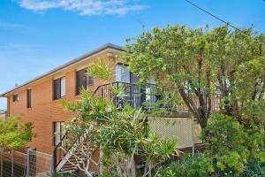 an apartment building with trees in front of it at Elsewhere 3- Town Location - Stone Real Estate Yamba in Yamba