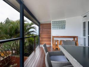 a room with a balcony with a table and chairs at Pippi Sands - Pet Friendly - Stone Real Estate in Yamba