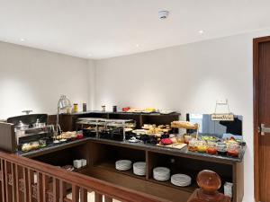a kitchen with a buffet of food on display at Pavilion Essence Hanoi Hotel in Hanoi +31 photos