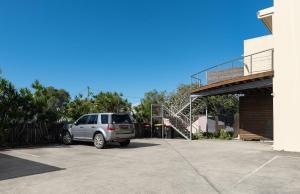 a silver suv parked in a parking lot at Six River - Town Location - Stone Real Estate Yamba in Yamba +16 photos