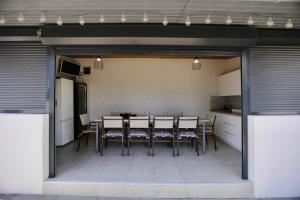 a dining room with a table and chairs in a garage at VLD House A Frame in Vadu