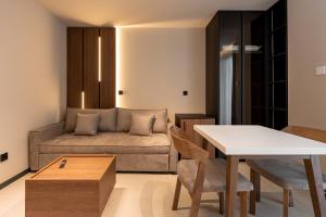 a living room with a couch and a table at AVAIA boutique hotel in Nea Moudania