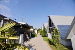 a walkway between two houses with a blue roof at VLD House A Frame in Vadu