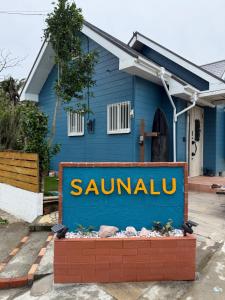 a blue house with a sign in front of it at saunalu in Kido +37 photos