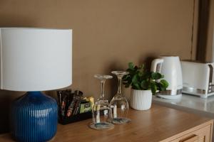 a table with a blue vase and a lamp on it at Great Keppel Island Hideaway in Great Keppel