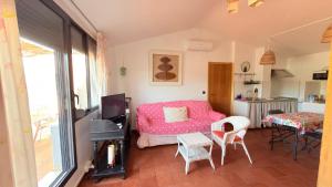 a bedroom with a pink bed and a table and chairs at Loft El Carmen in Teruel