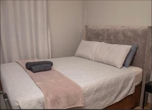 a small bed in a small room with a pillow at MbaliBliss in Bulawayo