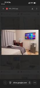 a bedroom with a bed and a tv on a wall at MbaliBliss in Bulawayo +3 photos