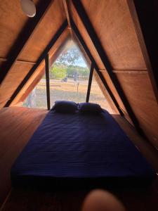 a bed in a tent with a window at Wild Roots Cabana Arugambay in Arugam Bay