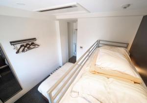 a small room with a bed in it at Super Hotel Asahikawa in Asahikawa