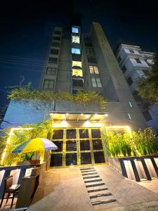 a building with a yellow umbrella in front of it at Elite Hotel Airport in Dhaka