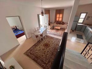 an aerial view of a living room with a table and chairs at djerba palm house in Mezraya