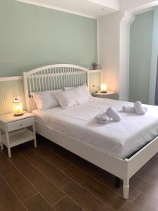 a white bed with two pillows on it in a bedroom at Casa vacanza Gea - Superior Apartment in Bergamo city with private parking car in Bergamo +33 photos
