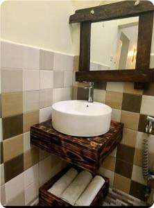 a bathroom with a sink and a mirror and towels at pumzika hill in Arusha