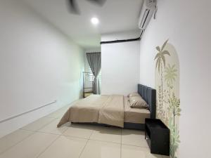 a bedroom with a bed in a white room at 4B 3R Cozy Spacious Near Dewan Millenium Fully Aircond in Kepala Batas +43 photos