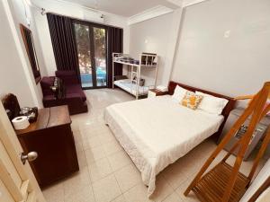 a bedroom with a bed and a chair in it at Khang Homestay in Danang +98 photos