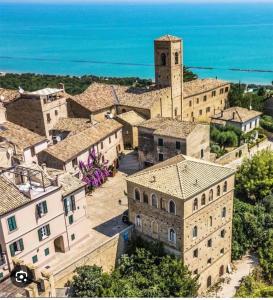 an aerial view of a village with a clock tower at Casa Marina mare e relax in Marina Palmense