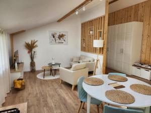 a living room with a table and chairs at Appartement in Lorp Sentaraille