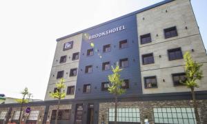 a building with a sign on the side of it at Brooks Hotel Tongyeong in Tongyeong