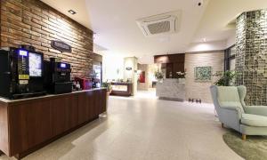 a lobby with a cash register and chairs in a store at Brooks Hotel Tongyeong in Tongyeong