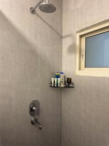 a bathroom with a shower with a window at Studio By The Garden in Jawlakhel +11 photos