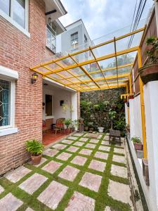 an outdoor patio with a yellow pergola at Studio By The Garden in Jawlakhel