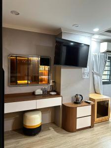 a room with a kitchen with a tv on the wall at Motel Mỹ Vân in Can Tho +22 photos