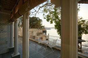 a view of the water from the porch of a house at Paddy's Loft The Lake B&B in Udaipur