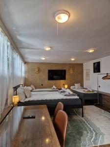 a bedroom with a large bed and a table at Apartamenty Traugutta 47 in Radom