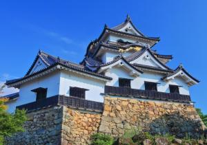 a tall building on top of a stone wall at Super Hotel Minami Hikone Ekimae in Hikone